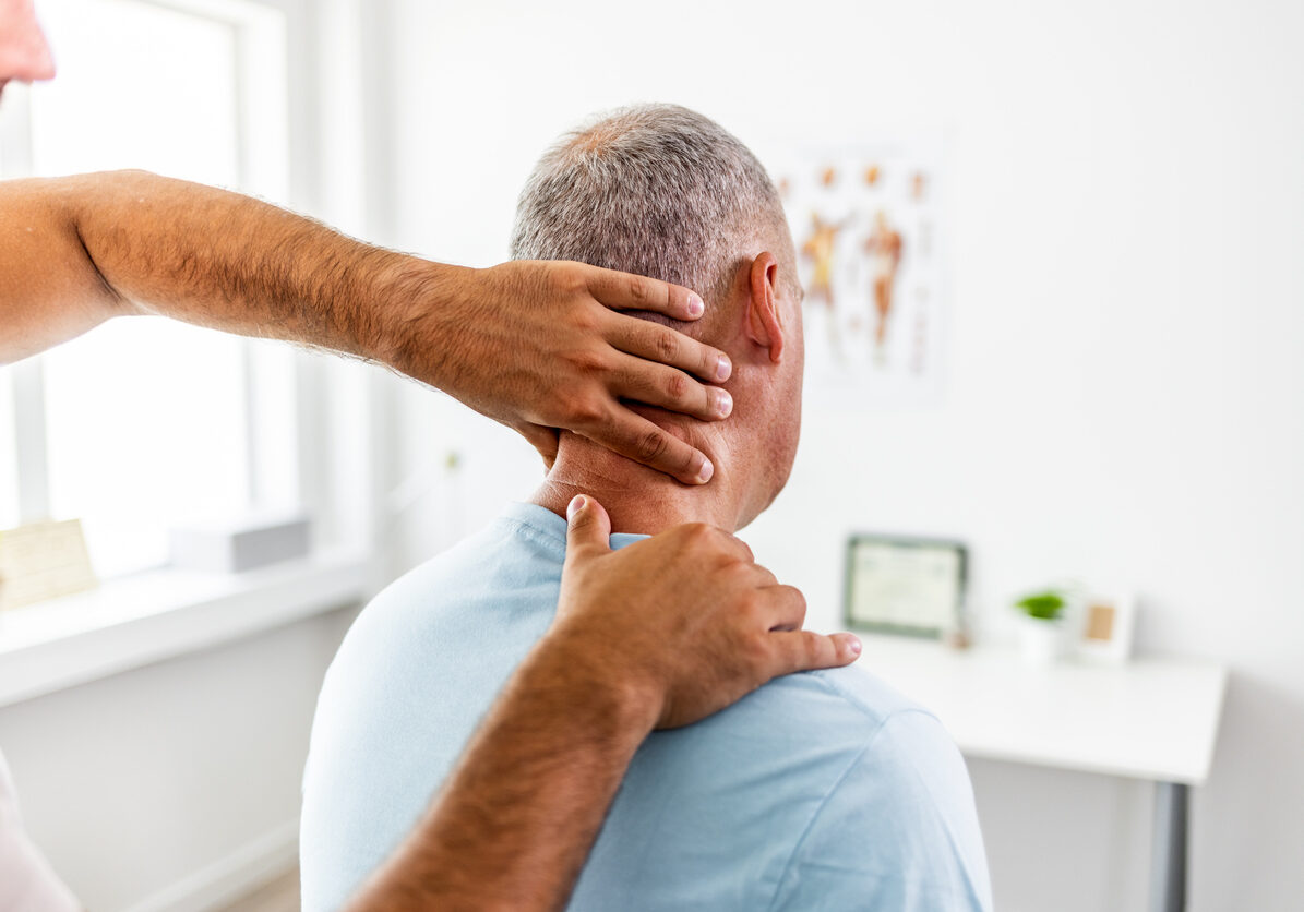 Mature man shares symptoms with his doctor.