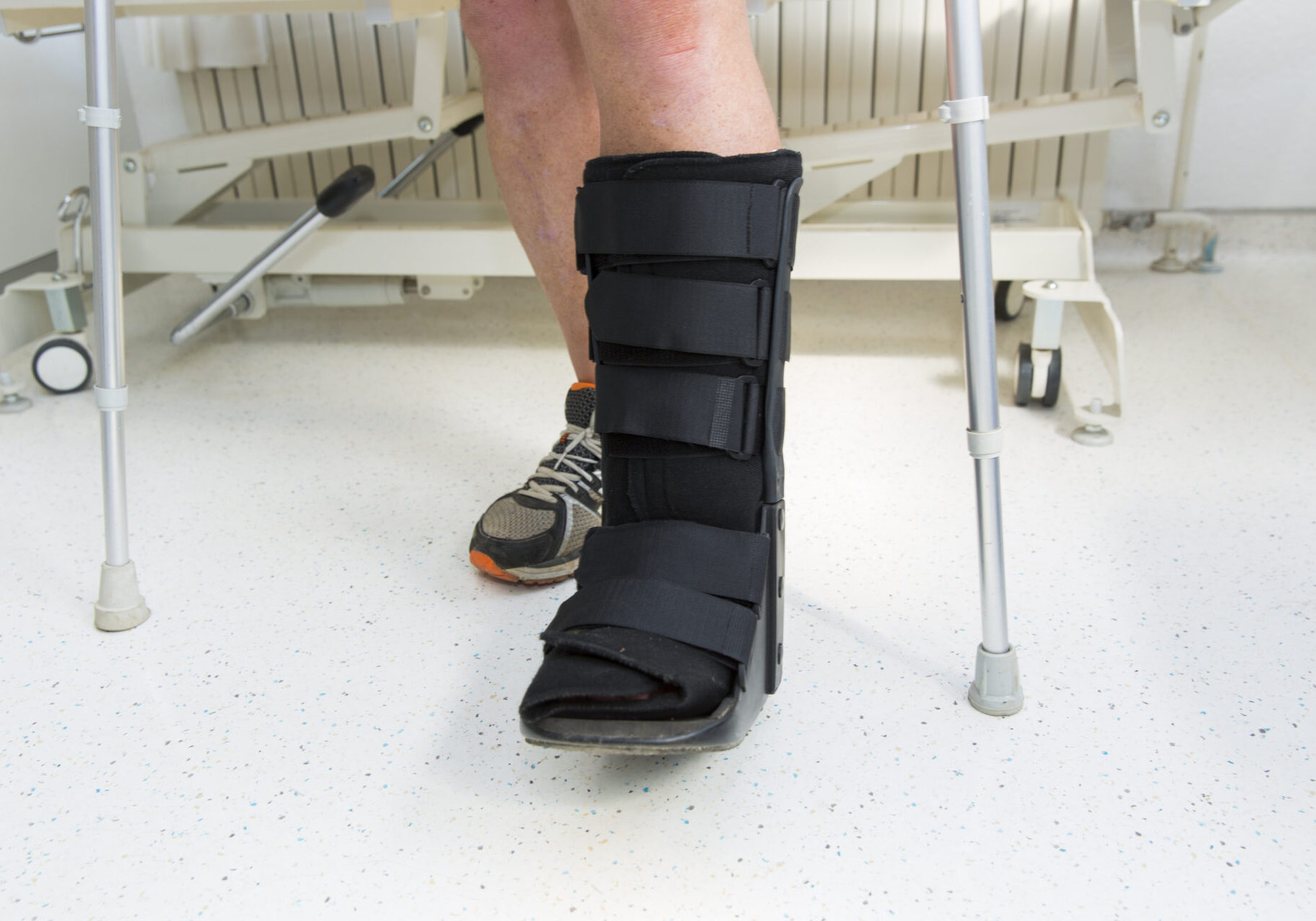 Muscular athlete with Walking boot for achilles tendon treatment
